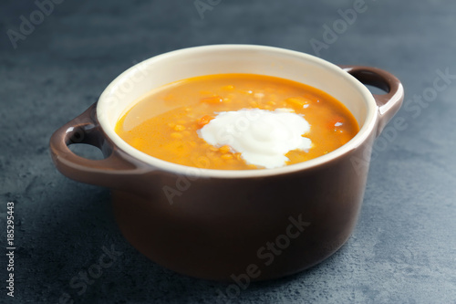 Dish with tasty lentil soup on table
