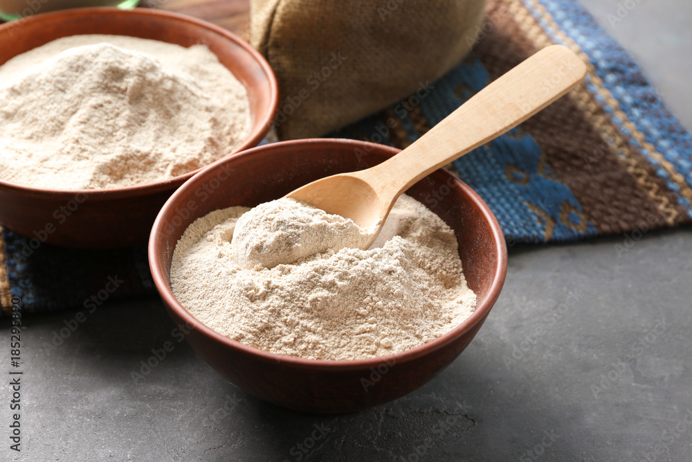 Bowls with buckwheat flour on table Bowls with buckwheat flour on table