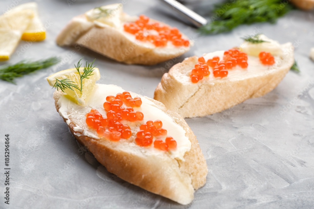 Tin can with delicious red caviar, dill and sandwich on table Tin can with delicious red caviar, dill and sandwich on table