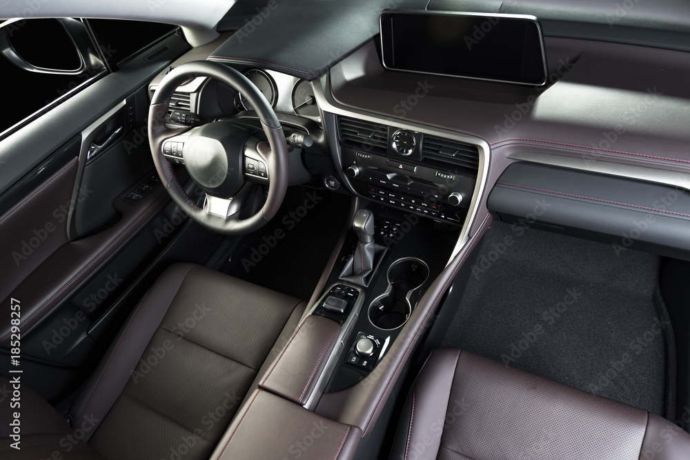 Modern luxury car interior, dashboard, steering wheel. Red perforated leather interior Modern luxury car interior, dashboard, steering wheel. Red perforated leather interior