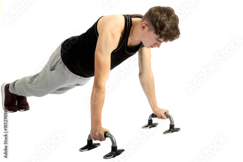 18 year old teenage boy exercising with weights