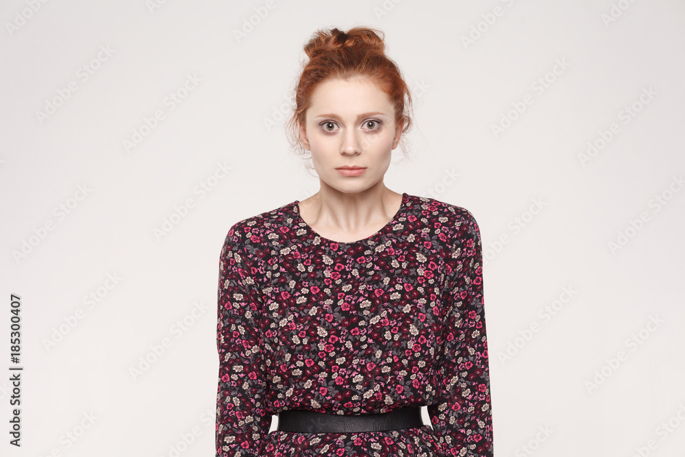  Portrait of unhappy and depressed woman with ginger hair feeling ashamed or sick, covering face with both hands, keeping eyes closed.