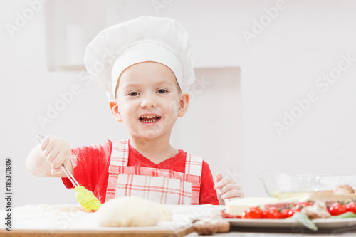 Boy with chef hat preparing...