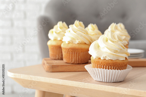 Tasty cupcakes on table