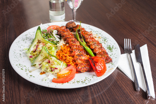 Adana kebap with rice and vegetables photo