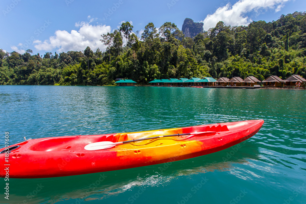 Canoe in a beautiful mountains lake forest and river natural attractions in Ratchaprapha Dam at Khao Sok National Park, Surat Thani Province, Thailand. Canoe in a beautiful mountains lake forest and river natural attractions in Ratchaprapha Dam at Khao Sok National Park, Surat Thani Province, Thailand.