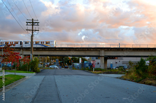 Peculiar urban scape of Vancouver (BC) Canada. A wide road, autumn colors and the skytrain line passing by © eugpng