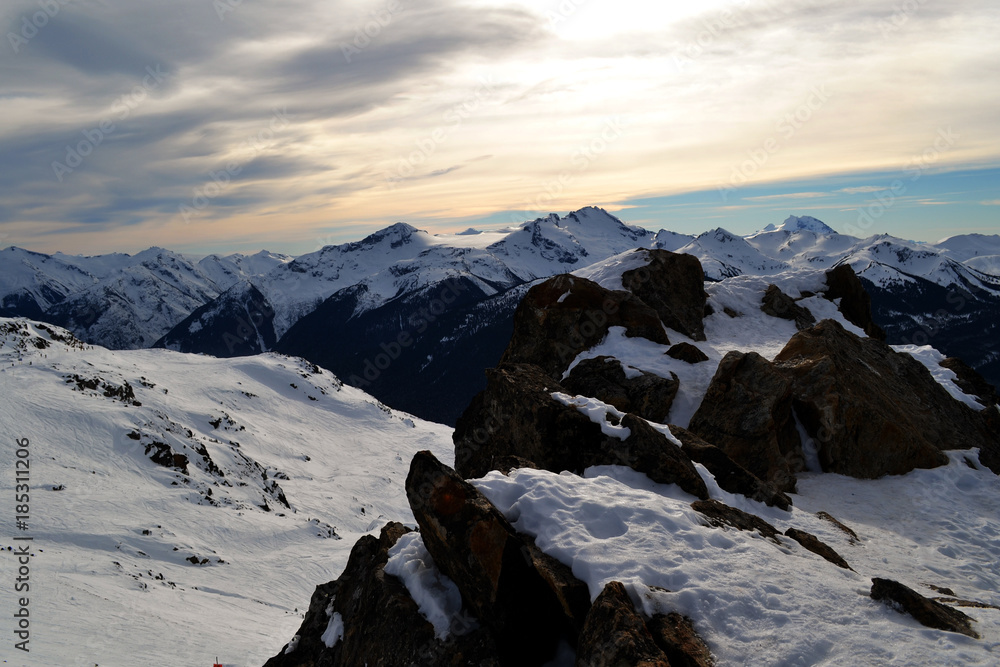 Obraz premium Landscape aerial view of the rocky Mountains full of snow seen from the ski slopes of Whistler, near Vancouver in British Columbia, Canada