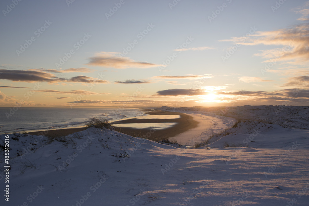 Scenic view of Sunset over Snowy Beach