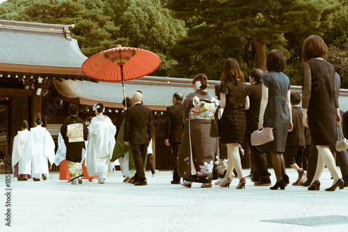 The procession of a Japanese Shinto wedding at the famous Meiji Shrine in Tokyo, Japan. The shrine is a popular site for marriage ceremonies. On busy weekends, it carries out around 15 weddings.