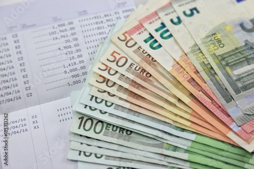 Картината върху платно Many euro banknotes and bank account passbook show a lot of transactions