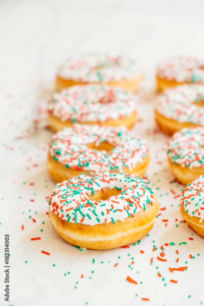 Donuts with white chocolate cream and sprinkles sugar Donuts with white chocolate cream and sprinkles sugar