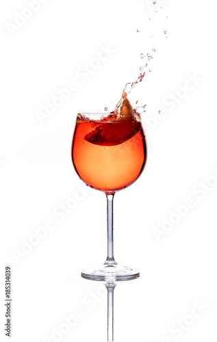 Sliced orange fruit splash in a glass with oragne liquid