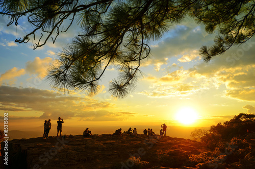 Silhouette of people enjoyed sunset view at the mountain top.