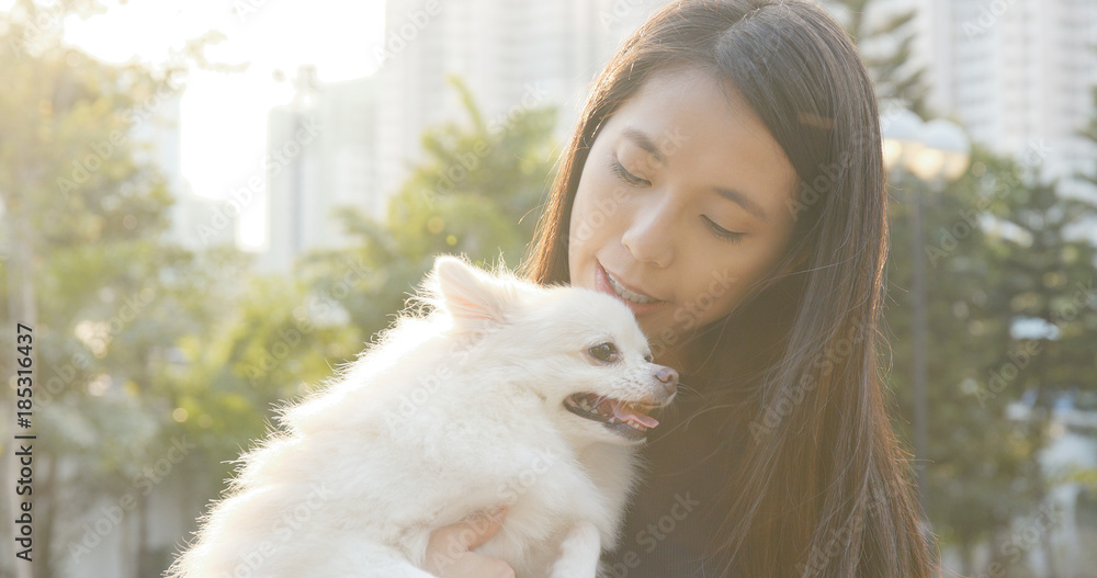 Woman hugging Pomeranian dog Woman hugging Pomeranian dog