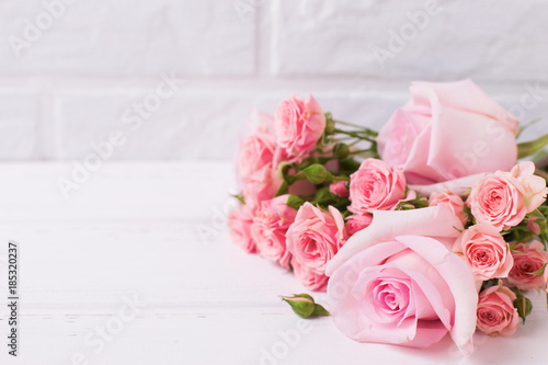 Tender pink roses flowers  on  white wooden background. © daffodilred