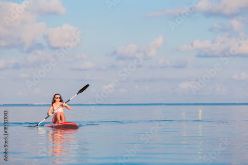 Active young woman on stand up paddle board © travnikovstudio