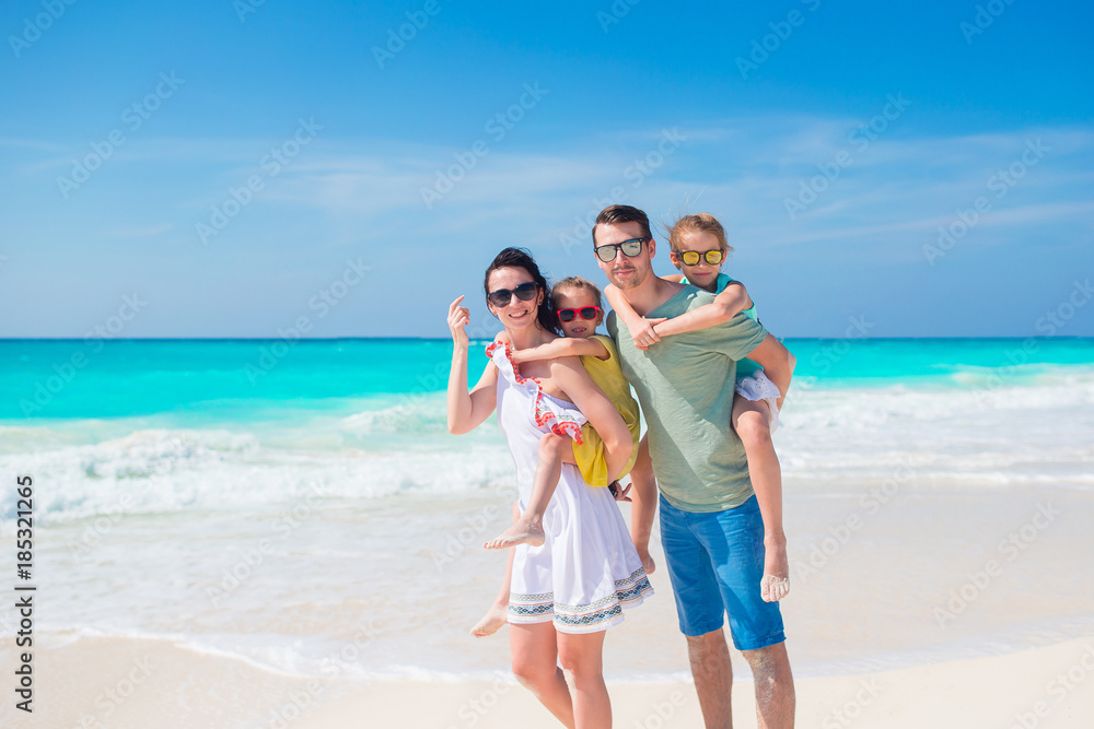 Family of four on beach vacation having a lot of fun Family of four on beach vacation having a lot of fun