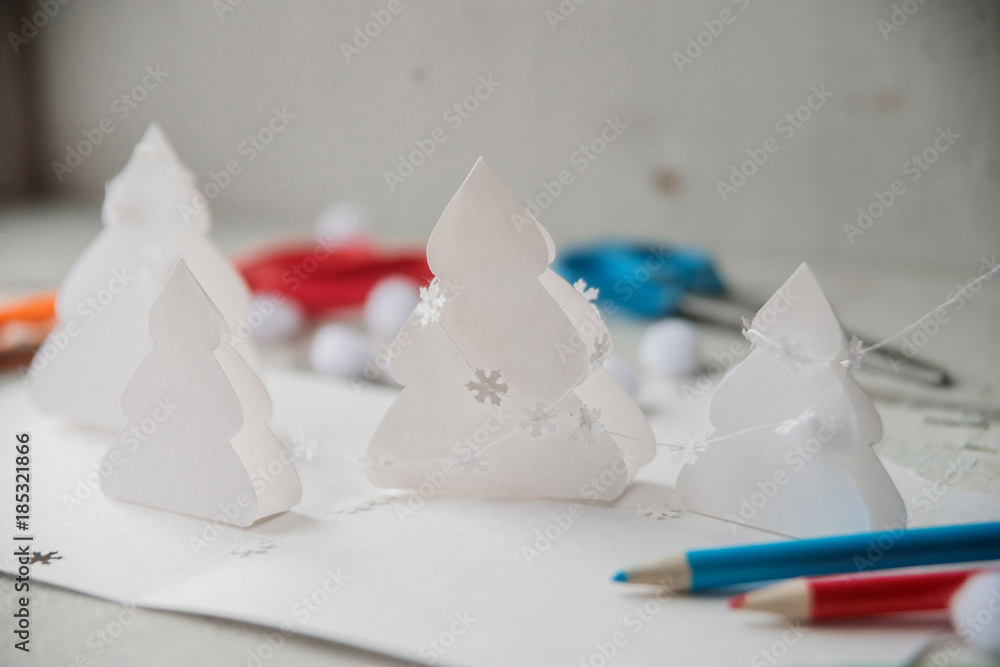 Christmas table with various items. Woman's hands putting a letter in an envelope Christmas table with various items. Woman's hands putting a letter in an envelope
