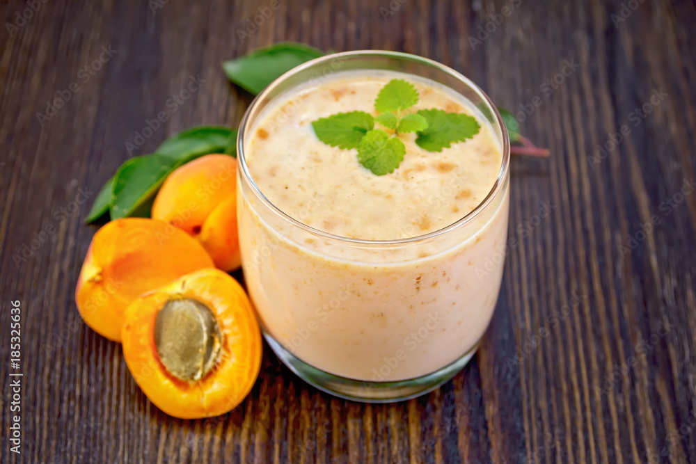 Milkshake apricot in glassful on board Milkshake apricot in glassful on board
