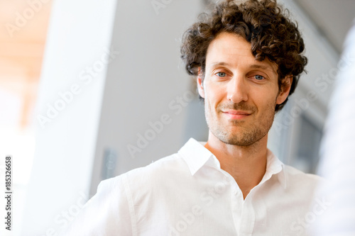 Portrait of a smart young man indoors