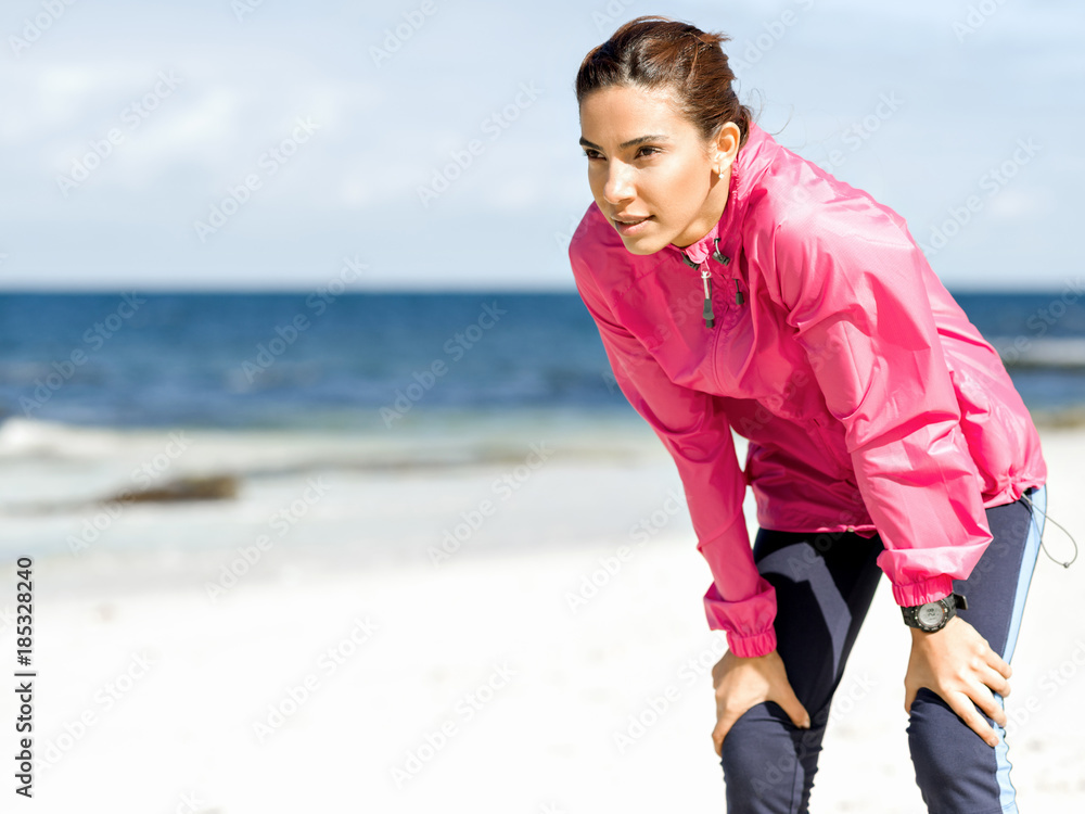 Exhausted fitness woman taking a break after running Exhausted fitness woman taking a break after running