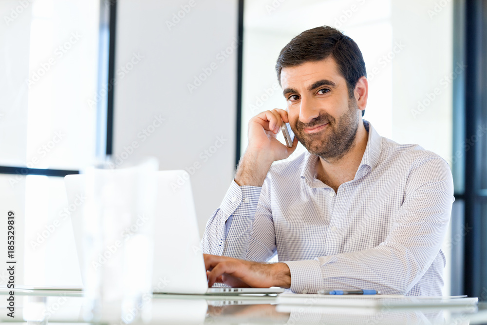 Confident young man in smart casual wear holding phone Confident young man in smart casual wear holding phone