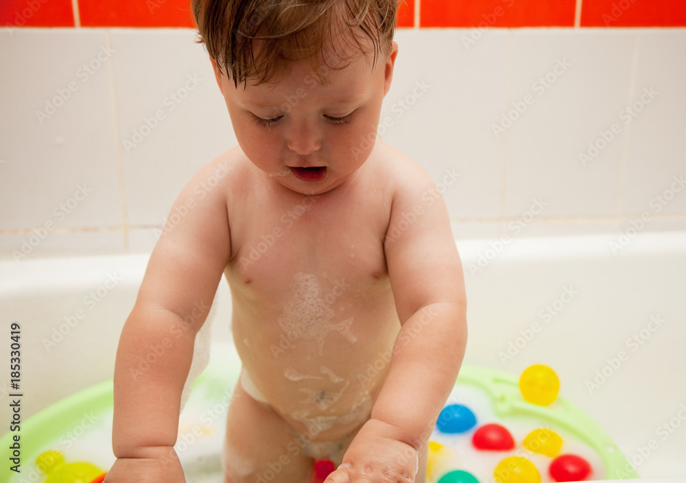 the kid plays with toys in water in the bathroom the kid plays with toys in water in the bathroom