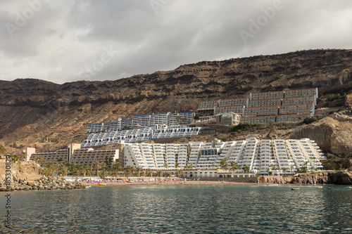 Taurito, Gran Canaria. Beach and hotels seen from the sea, overcast weather