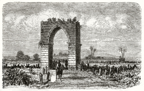Desolated ancient cemetery with the ruins of a stone vaulted door on the center. Old view of the Iron Gate Tarsus Turkey. Created by Grandsire and Gaushard published on Le Tour du Monde Paris 1862 photo