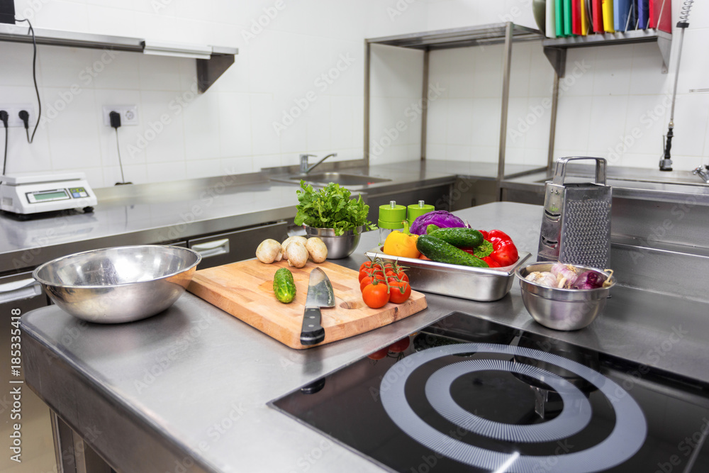 Various vegetables and kitchenware on a kitchen table in a restaurant Various vegetables and kitchenware on a kitchen table in a restaurant