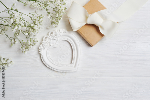 Mock up Composition of white flowers rustic style, hearts love and a gift for St. Valentine's Day with a place for your text. Flat lay, top view photo mock up