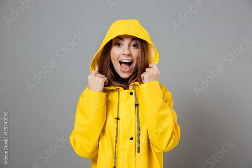 Portrait of a joyful girl dressed in raincoat photo