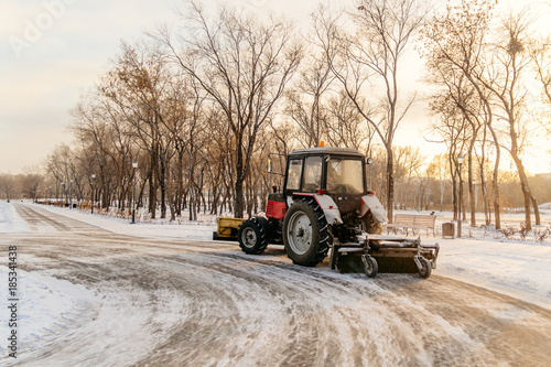 tractor cleans snow in the park, cleaning equipment