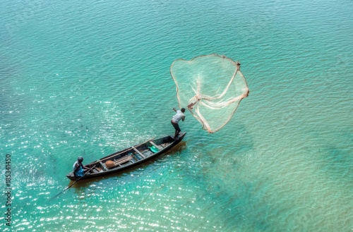 Fisherman casting his net in The Brahmaputra river , Assam, India. photo