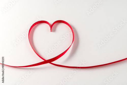 Heart made of ribbon on white background. Valentines day. © Paopano