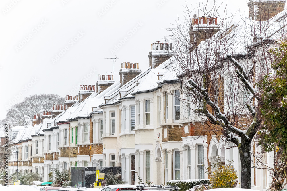 Fototapeta premium Terraced houses covered with snow around West Hampstead area in London