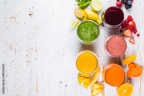 Selection of colourful smoothies on rustic wood background