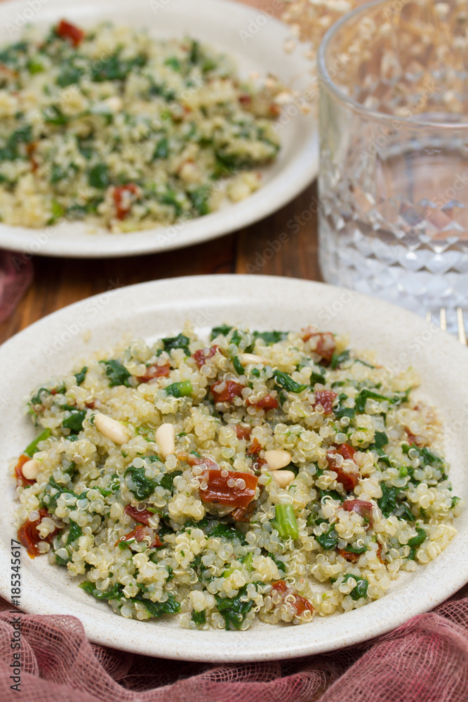 salad quinoa with kale and dried tomato on white plate salad quinoa with kale and dried tomato on white plate