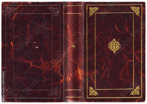 Antique open book with purple leather cover and embossed golden decorations