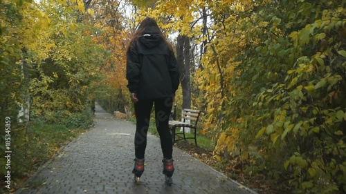 Wallpaper Mural Young Woman On Roller Skates among beautiful autumn trees Torontodigital.ca