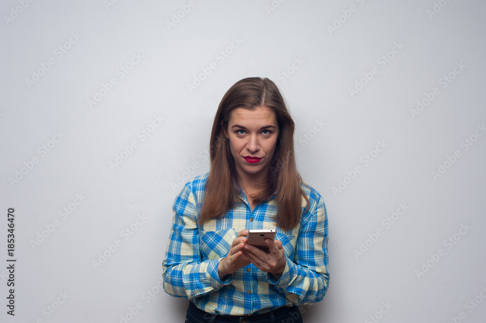Portrait of young beautiful businesswoman with smartphone in casual clothes on white background. Copyspase Portrait of young beautiful businesswoman with smartphone in casual clothes on white background. Copyspase