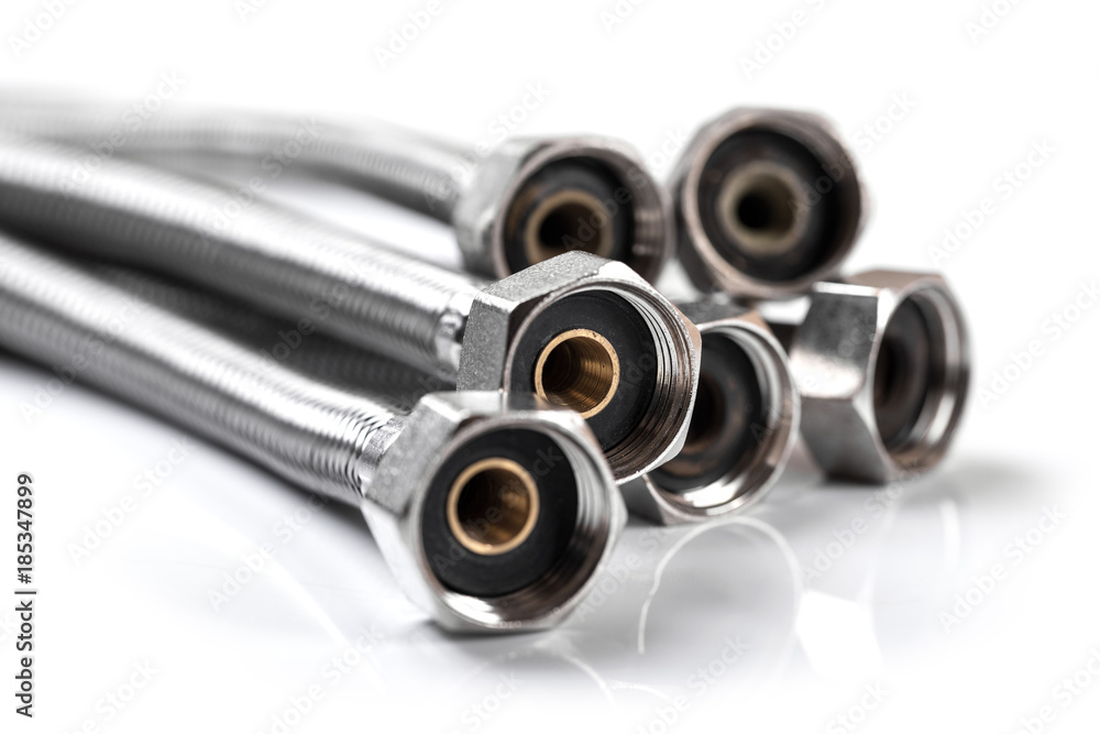plumbing equipment - flexible braided water hoses isolated on white plumbing equipment - flexible braided water hoses isolated on white