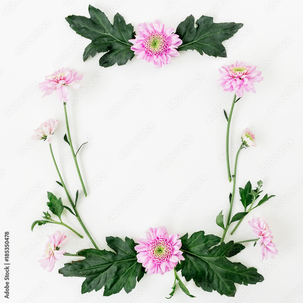 Floral frame with pink flowers and leaves on white background. Flat lay, top view. Valentines day composition