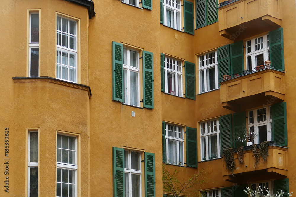 Gelbe Fassade mit grünen Fensterläden