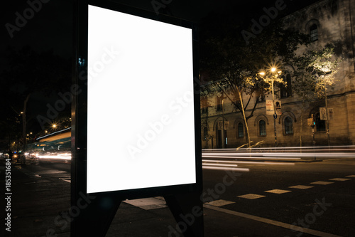 Blank advertisement lightbox in the street at night. Display mock-up. Business banner.