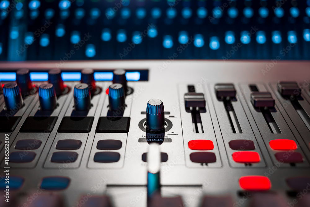 digital audio mixer in recording, editing, broadcasting studio. shallow dept of field. music background