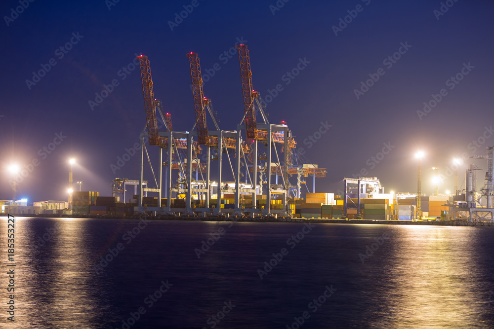 industrial port with containers at night time. Container terminal of industrial port in night.