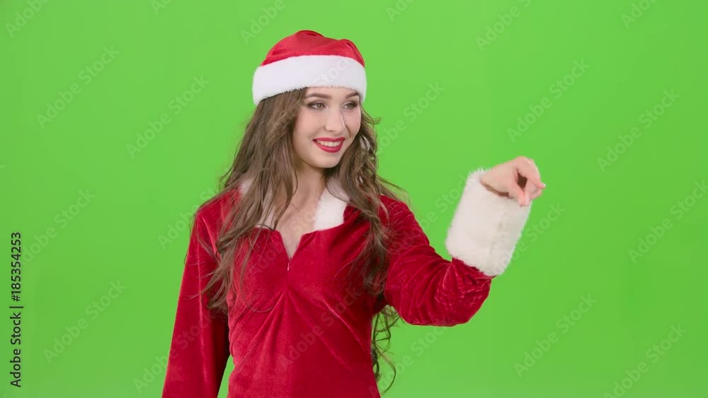 Santas assistant draws an airy congratulation on the new year. Green screen