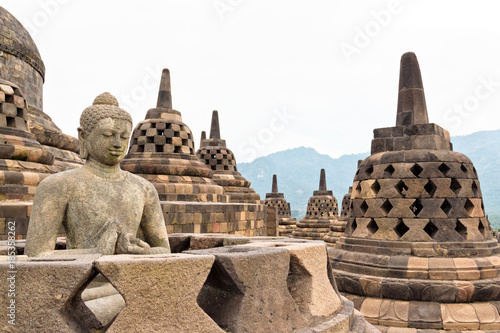 Buddah statue with ancient stupas in Borobudur Buddhist temple